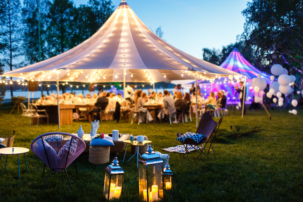 Marquee Wedding - A beautifully decorated wedding tent featuring soft lights and candles, creating a romantic atmosphere for a marquee wedding.