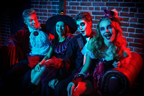 Teenagers dressed in costumes for a themed costume party.